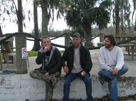 Helpers take a smoke break - note the no smoking sign on post